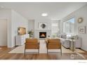 Bright living room with modern fireplace, stylish chairs, and plenty of natural light at 1312 Loraine S Cir, Lafayette, CO 80026