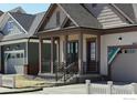 A covered front porch offers outdoor charm at 1641 Poplar Dr, Erie, CO 80516