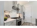 A well-equipped kitchen offers abundant storage with its modern cabinets and stainless steel appliances at 1641 Poplar Dr, Erie, CO 80516