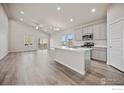Bright and airy kitchen featuring modern appliances and an island at 196 Bird Way, Lochbuie, CO 80603