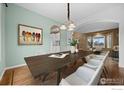 Charming dining area featuring wood floors and stylish lighting fixtures at 2275 Schooner St, Lafayette, CO 80026
