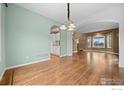 Charming dining area featuring wood floors and stylish lighting fixtures at 2275 Schooner St, Lafayette, CO 80026