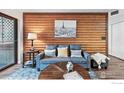 Comfortable living room with wood paneled wall and artwork at 2727 Folsom St # 228, Boulder, CO 80304
