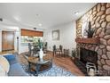 Cozy living room features a stone fireplace, hardwood floors and a dining area at 2727 Folsom St # 228, Boulder, CO 80304