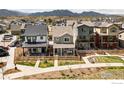Aerial view of stylish homes with charming yards; stunning mountain views add to the serene neighborhood ambiance at 320 Marshall Mews, Superior, CO 80027