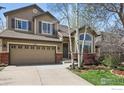 Charming two-story home featuring a two-car garage, brick accents, and landscaped front lawn at 3235 Basalt Ct, Superior, CO 80027