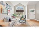 Bright living room with vaulted ceilings, large window, hardwood floors, and stylish decor at 3235 Basalt Ct, Superior, CO 80027