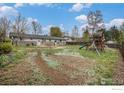 Spacious backyard featuring a playset, grassy area, and full fencing for privacy at 339 Indiana Ave, Berthoud, CO 80513
