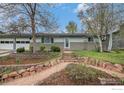 Charming single-story home with beautiful landscaping and a stone pathway leading to the front door at 339 Indiana Ave, Berthoud, CO 80513
