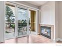 Bright living room with wood floors, gas fireplace, and balcony access to outdoor seating at 4500 Baseline Rd # 3203, Boulder, CO 80303
