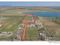 Aerial view of property boundary including house, outbuildings, and adjacent lake at 524 E County Road 8, Berthoud, CO 80513