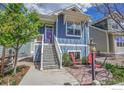 Lovely blue home featuring a quaint front patio, perfect for enjoying the outdoors at 541 Hoyt Ln, Lafayette, CO 80026