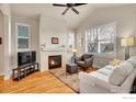 Light-filled living room featuring a fireplace and hardwood floors, creating a warm and inviting atmosphere at 541 Hoyt Ln, Lafayette, CO 80026