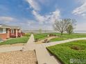 Tranquil backyard with mature trees, lush greenery, and water views at 5425 County Road 32 # 15, Mead, CO 80504