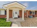 Welcoming front door with peaked roof and small walkway and garden at 5425 County Road 32 # 15, Mead, CO 80504