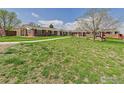 Expansive front lawn featuring well-maintained landscaping and charming brick buildings at 5425 County Road 32 # 15, Mead, CO 80504