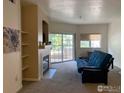 Inviting living room showcasing a fireplace, balcony access, and soft carpeting at 560 Mohawk Dr # 35, Boulder, CO 80303