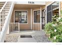 Charming front porch with decorative rug and plantings near front door of condo at 5934 Gunbarrel Ave # D, Boulder, CO 80301