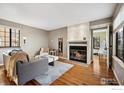 Bright living room featuring a cozy fireplace, hardwood floors, and comfortable seating at 5934 Gunbarrel Ave # D, Boulder, CO 80301