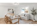 Cozy living room with a large window, white sofa, and stylish decor at 6877 Gray Dr, Arvada, CO 80003