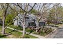 A charming gray home with mature trees and a well-manicured lawn creates a welcoming atmosphere at 7126 Cedarwood Cir, Boulder, CO 80301