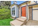 Close up of the front door with brick facade and blue accent trim, showing the entry to the home at 719 Cameron Ln, Longmont, CO 80504