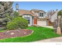 Charming two-story home with fresh exterior paint and lush landscaping and a two car garage at 719 Cameron Ln, Longmont, CO 80504
