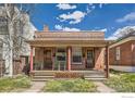 Full front view of the brick duplex, showing the shared front porch and individual unit entrances at 72 N Pennsylvania St, Denver, CO 80203