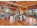 Open-concept dining room with wood floors, high ceilings, exposed beams, and natural light at 7929 Valmont Rd, Boulder, CO 80301