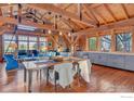 Bright and airy living space featuring wood floors, vaulted ceilings and mountain views at 7929 Valmont Rd, Boulder, CO 80301