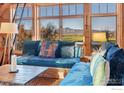 Cozy living room nook with custom seating and views of the green fields and mountains at 7929 Valmont Rd, Boulder, CO 80301