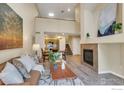 Bright living room features a fireplace, high ceilings, and an open floor plan to the kitchen and dining area at 805 Summer Hawk Dr # Bb164, Longmont, CO 80504