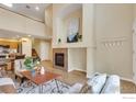 Open-concept living room with cozy fireplace, neutral decor, and hardwood flooring at 805 Summer Hawk Dr # Bb164, Longmont, CO 80504