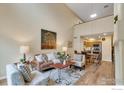 Bright and airy living room featuring vaulted ceilings, hardwood floors, and modern furnishings at 805 Summer Hawk Dr # Bb164, Longmont, CO 80504
