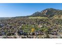 Expansive aerial view showcases home's setting, lush surroundings, and mountain backdrop at 838 University Ave, Boulder, CO 80302