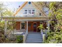 Inviting home with a red door, featuring a charming porch and second story balcony at 838 University Ave, Boulder, CO 80302