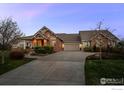 Attractive home with a long drive, professional landscaping and charming exterior finishes at 8392 Niwot Meadow Farm Rd, Niwot, CO 80503