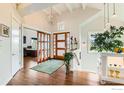 Grand foyer with wood floors, high ceilings, and stylish lighting at 8392 Niwot Meadow Farm Rd, Niwot, CO 80503