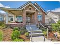 Inviting front porch with seating and a well-maintained stone facade at 8392 Niwot Meadow Farm Rd, Niwot, CO 80503