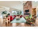 Spacious living room featuring a stone fireplace and large windows at 8392 Niwot Meadow Farm Rd, Niwot, CO 80503