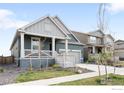 Beautiful home featuring a welcoming front porch, manicured lawn, and an inviting exterior at 840 Clover Loop, Lafayette, CO 80026
