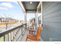 Inviting front porch with rocking chairs, perfect for relaxing and enjoying the neighborhood views at 840 Clover Loop, Lafayette, CO 80026