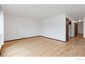 Bright living room featuring hardwood floors and a neutral color palette throughout at 9 Seattle Ln, Longmont, CO 80501