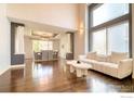 Bright living room featuring oversized windows, hardwood floors, and modern decor at 10583 Oakmoor Cir, Parker, CO 80134