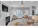 Bright living room featuring a fireplace, built-in shelving, neutral walls, and shuttered windows at 1121 Lincoln Ave, Louisville, CO 80027