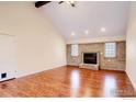 Inviting living room with brick fireplace, vaulted ceilings, and bright windows at 130 Ash St, Hudson, CO 80642