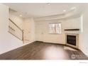Bright living room with a fireplace, neutral walls, and hardwood floors at 1320 Kestrel Ln # E, Longmont, CO 80501