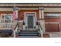 Elegant front porch with stone pillars and steps leading to the main entrance at 13360 W 83Rd Pl, Arvada, CO 80005