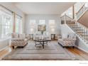 Bright living room featuring a staircase and lots of natural light at 13360 W 83Rd Pl, Arvada, CO 80005