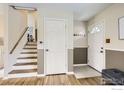 Inviting entryway features a staircase, coat closet, and easy access to the upper level at 1352 S Terry St, Longmont, CO 80501